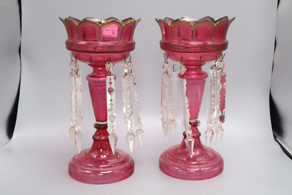 A pair of cranberry glass lustres, late 19th century, height 34cm